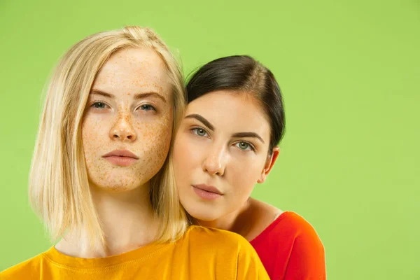 Portrait of pretty girls isolated on green studio background — Stock Photo, Image
