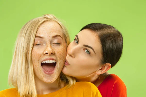 Portrait of pretty girls isolated on green studio background — Stock Photo, Image