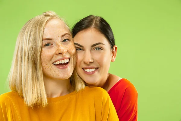 Portrait of pretty girls isolated on green studio background — Stock Photo, Image