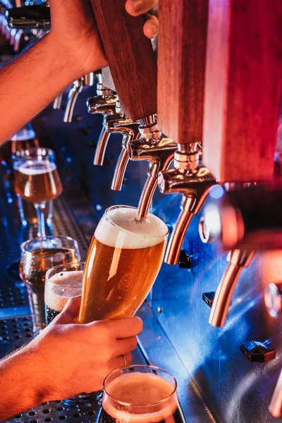 Hand of bartender pouring a large lager beer in tap — Stock Photo, Image