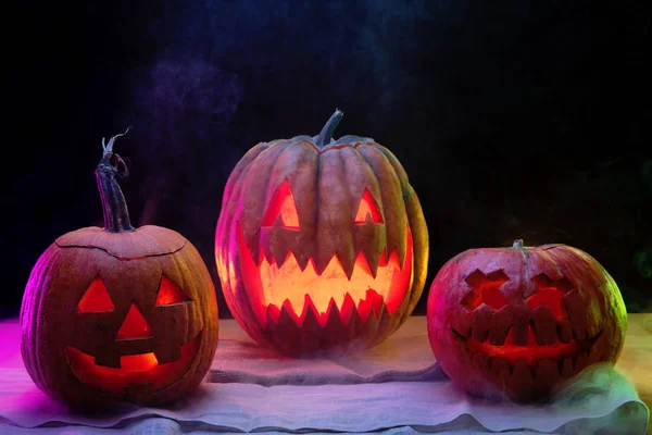 Halloween pumpkin head jack lantern with scary evil faces and candles — Stock Photo, Image