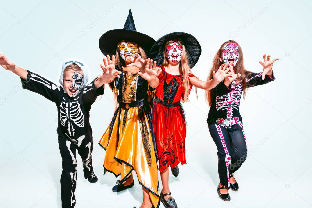 Kids or teens like witches and vampires on white background