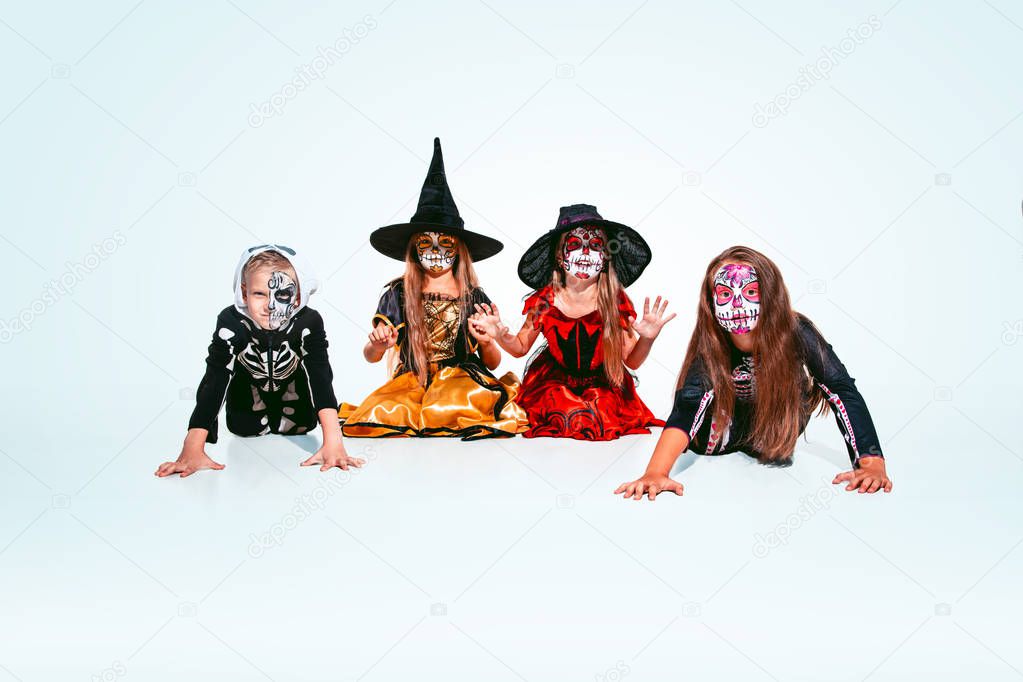 Kids or teens like witches and vampires on white background