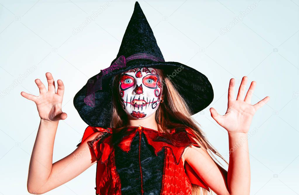 Little girl like a witch on white background
