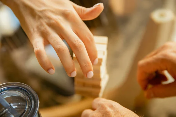 Close up of senior mans hands doing his wooden constructor at home - concept of home studying — Stock Photo, Image