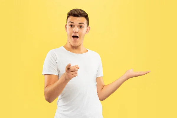 Caucasian young mans half-length portrait on yellow background — Stock Photo, Image