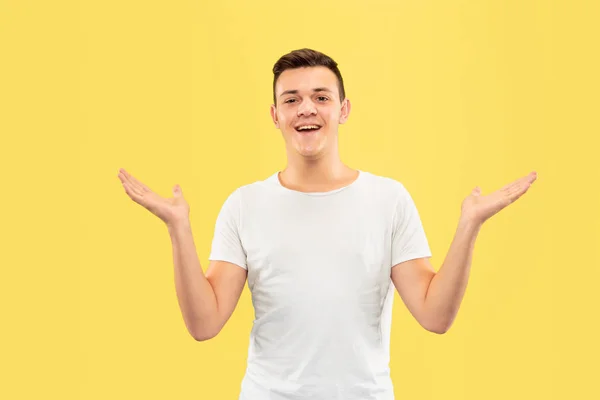 Caucasian young mans half-length portrait on yellow background — Stock Photo, Image