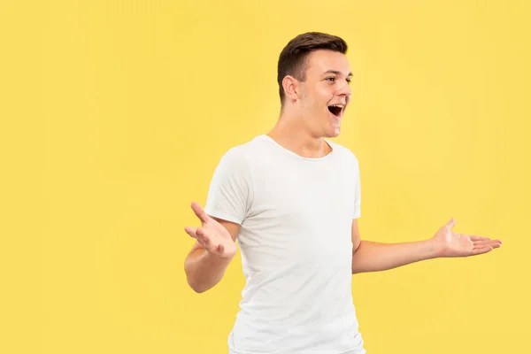 Caucasian young mans half-length portrait on yellow background — Stock Photo, Image