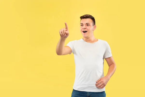 Caucasian young mans half-length portrait on yellow background — Stock Photo, Image