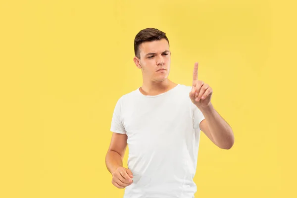 Caucasian young mans half-length portrait on yellow background — Stock Photo, Image