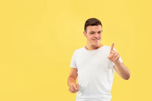 Caucasian young mans half-length portrait on yellow background — Stock Photo, Image