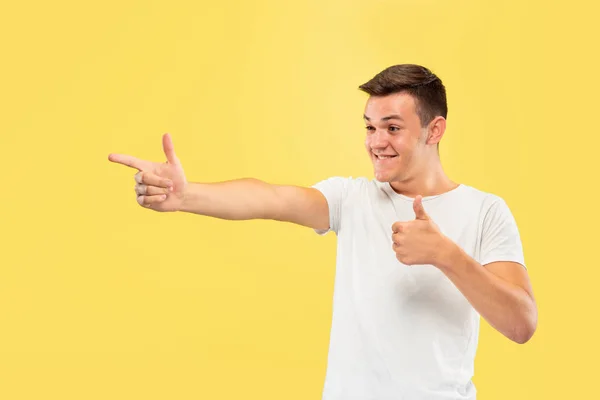 Caucasian young mans half-length portrait on yellow background — Stock Photo, Image