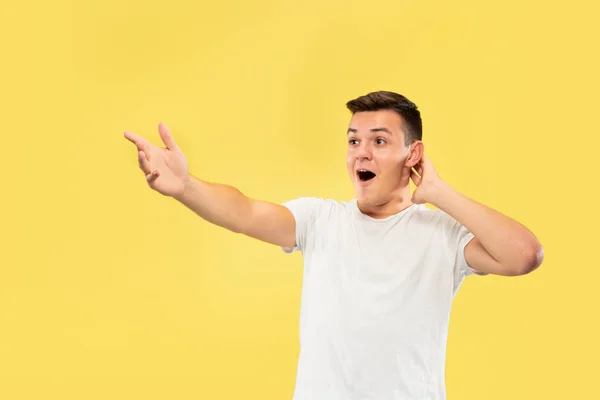 Caucasian young mans half-length portrait on yellow background — Stock Photo, Image