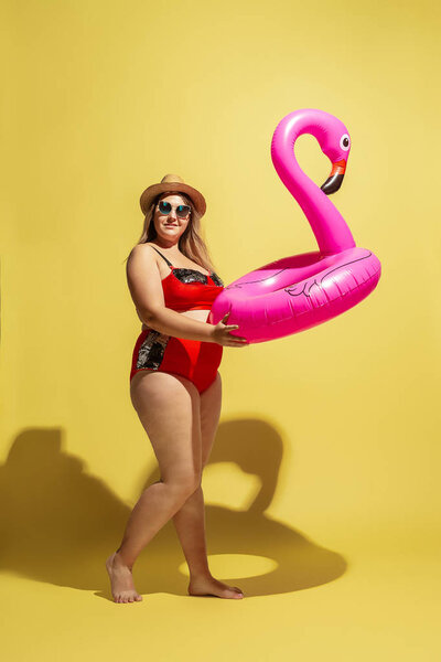 Young caucasian plus size female models preparing for beach resort