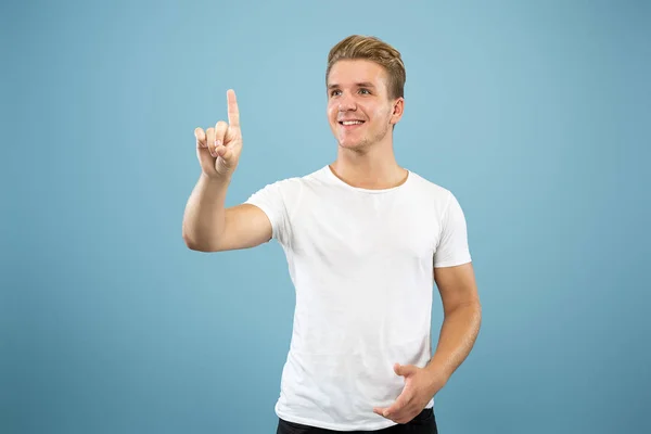 Caucasian young mans half-length portrait on blue background — Stock Photo, Image