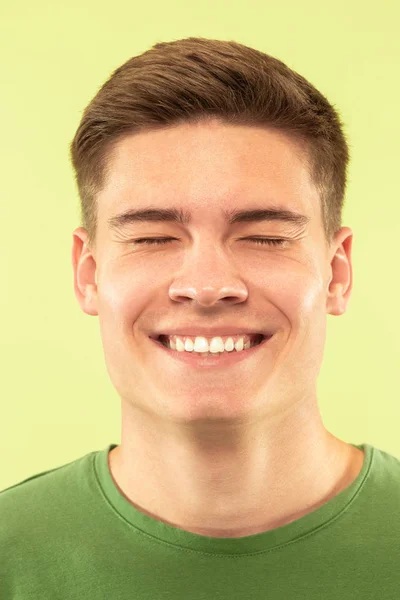 Caucasian young mans close up shot on green background — Stock Photo, Image