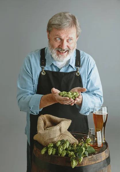 Confident senior man brewer with self crafted beer — Stock Photo, Image