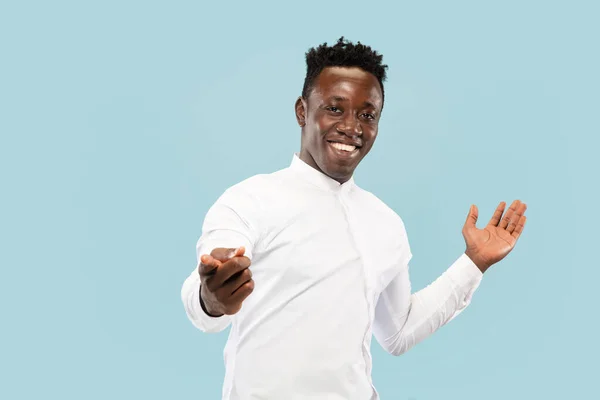 Hombre afroamericano joven aislado en fondo de estudio azul, concepto de emociones humanas . — Foto de Stock