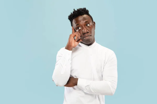 Young african-american man isolated on blue studio background, human emotions concept. — Stock Photo, Image