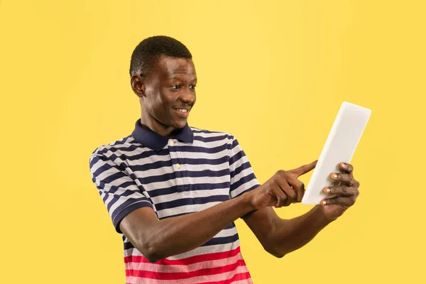 Νεαρός Αφροαμερικάνος απομονωμένος σε κίτρινο φόντο στούντιο, έννοια των ανθρώπινων συναισθημάτων. — Φωτογραφία Αρχείου