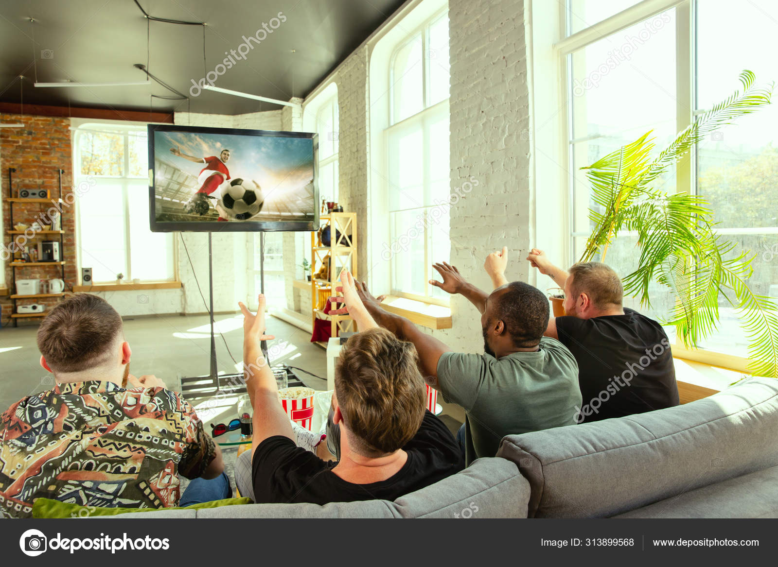 Group of friends watching football or soccer game on TV at home Stock Photo by ©vova130555@gmail 313899568