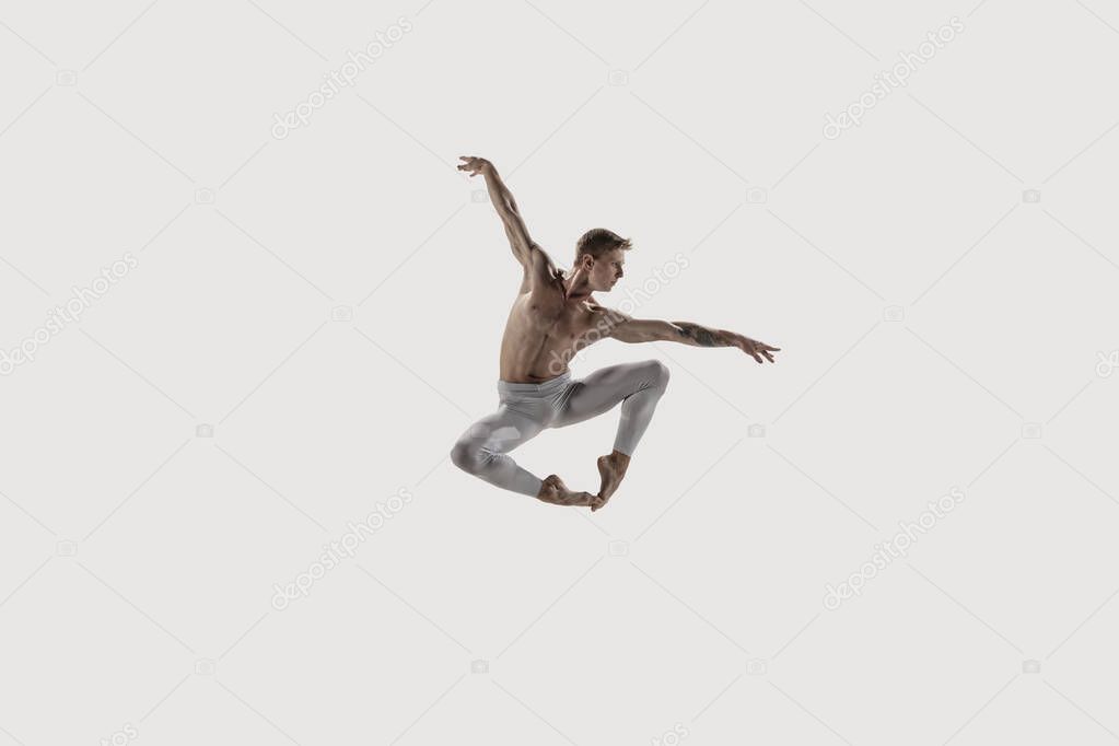 Modern ballet dancer. Contemporary art ballet. Young flexible athletic man.