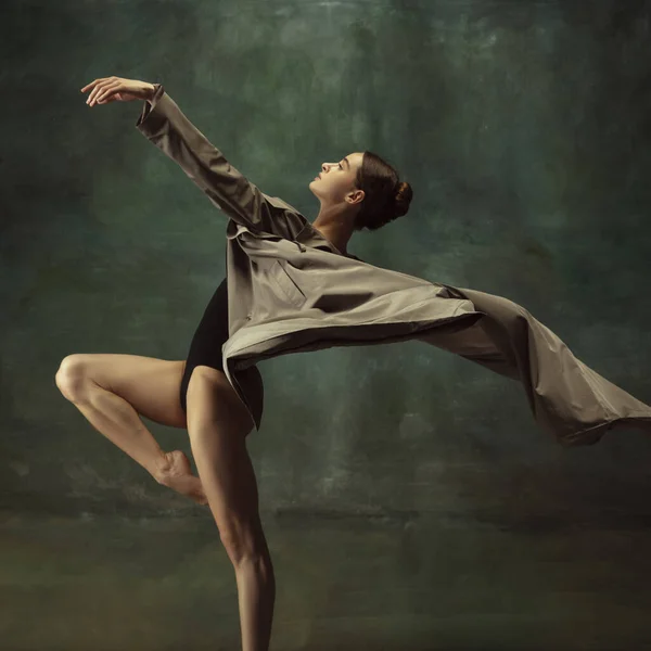 Young graceful tender ballerina on dark studio background — Stock Photo, Image