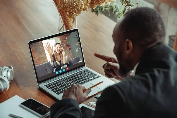 男は、仮想会議中にラップトップ画面を見てビデオ会議に参加します,ビジネスのためのビデオコールウェブカメラアプリ,クローズアップ — ストック写真