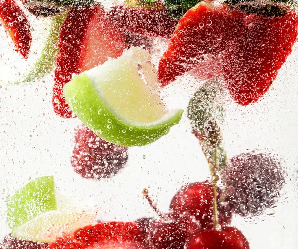 Close up view of the cold and fresh lemonade with bright berries in neon light — Stock Photo, Image