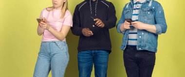 Bir grup arkadaş cep telefonu kullanıyor. Gençlerin yeni teknoloji eğilimlerine olan bağımlılığı. Kapat..