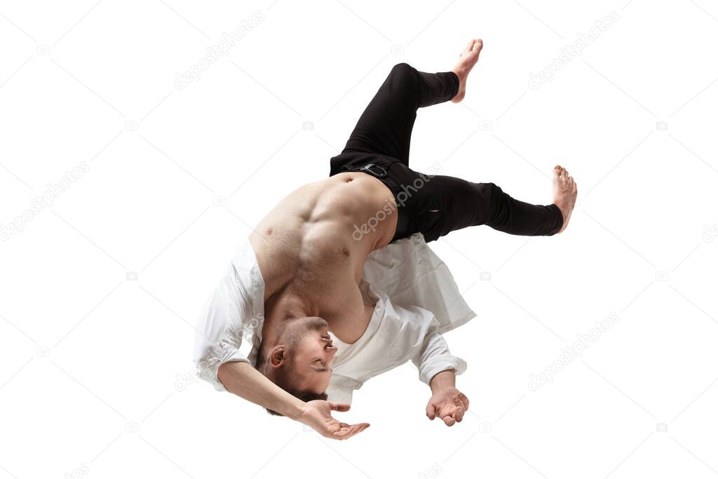 Mid-air beauty. Full length studio shot of attractive young man hovering in air and keeping eyes closed