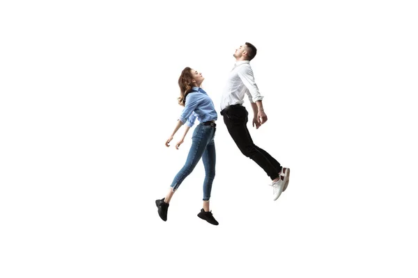Mid-air beauty. Full length studio shot of attractive young woman and man hovering in air and keeping eyes closed — Stock Photo, Image