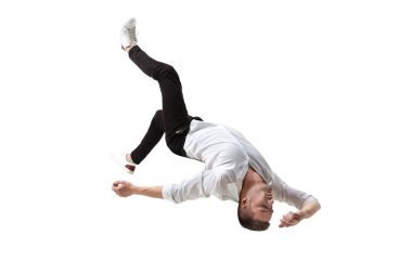 Mid-air beauty. Full length studio shot of attractive young man hovering in air and keeping eyes closed clipart