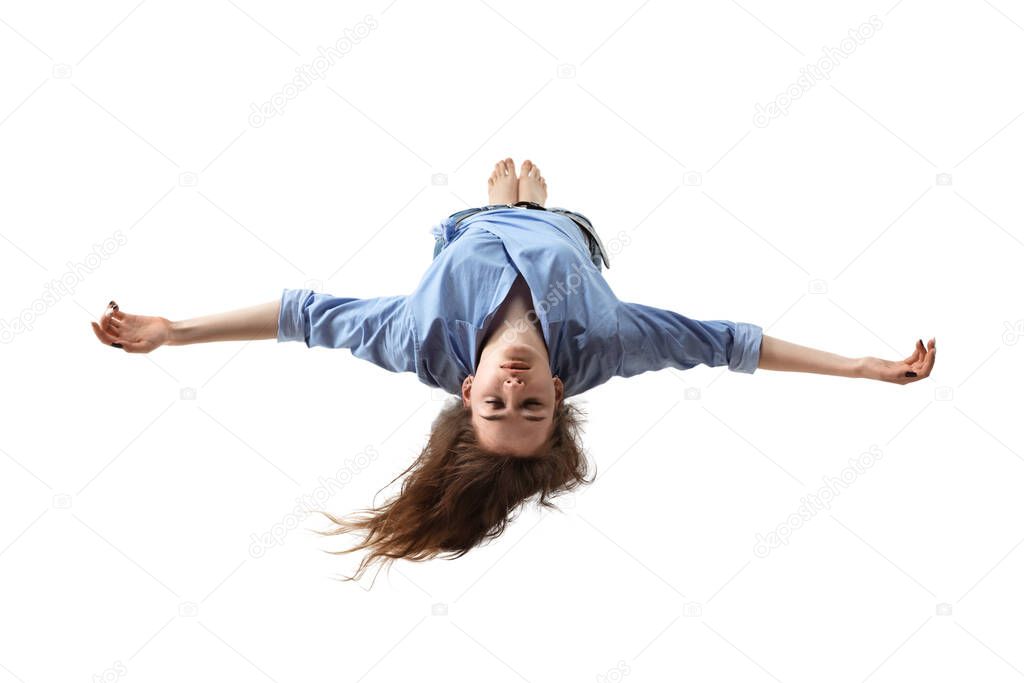 Mid-air beauty. Full length studio shot of attractive young woman hovering in air and keeping eyes closed