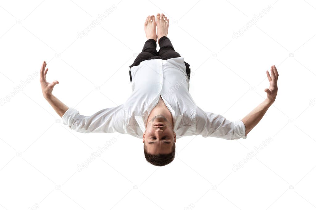 Mid-air beauty. Full length studio shot of attractive young man hovering in air and keeping eyes closed