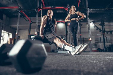Güzel, genç, sportif çift eğitimi, spor salonunda birlikte antrenman.