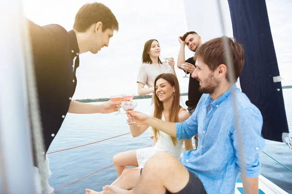 Grupo de amigos felices bebiendo cócteles de vodka en la fiesta en barco al aire libre, alegre y feliz —  Fotos de Stock