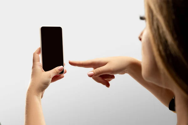 Крупним планом жіночі руки тримають смартфон з порожнім екраном під час онлайн-перегляду популярних спортивних матчів та чемпіонатів по всьому світу. Копія простору для реклами — стокове фото