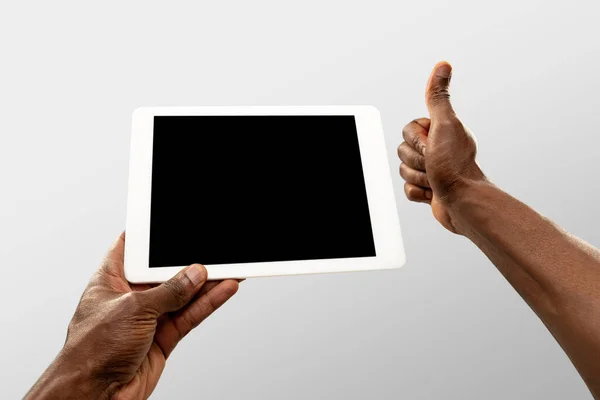 Close up male hands holding tablet with blank screen during online watching of popular sport matches and championships all around the world. Copyspace for ad — Stock Photo, Image