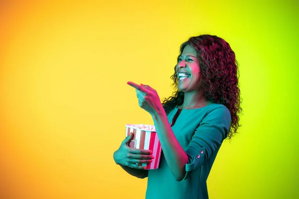 Africko-americké mladé ženy portrét izolovaný na gradient žlutozelené pozadí v neonovém světle — Stock fotografie