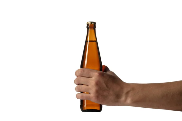 Empty golden colored beer bottle in male hand. Isolated on white studio background — Stock Photo, Image