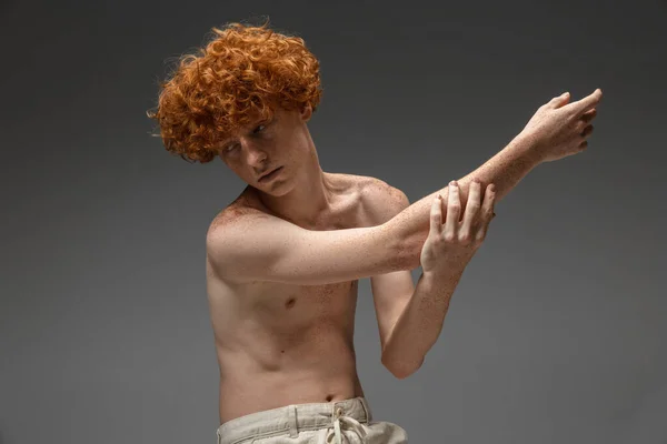 Portrait of beautiful redhead man isolated on grey studio background. Concept of beauty, skin care, fashion and style — Stock Photo, Image