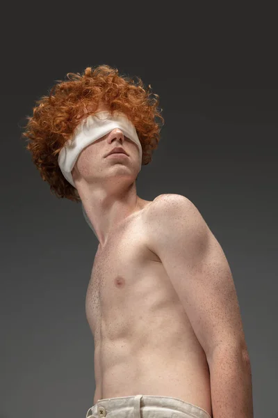 Portrait of beautiful redhead man isolated on grey studio background. Concept of beauty, skin care, fashion and style