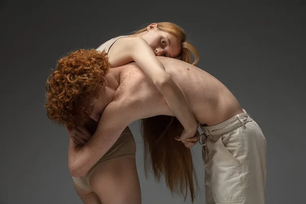 Portrait of beautiful redhead couple isolated on grey studio background. Concept of beauty, skin care, fashion and style — Stock Photo, Image