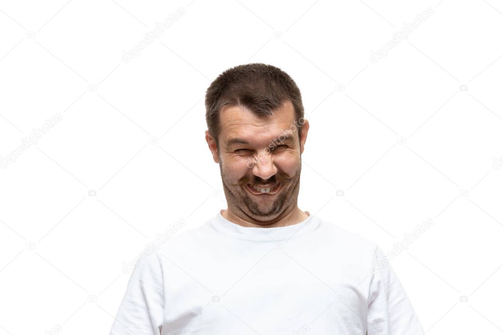 Young caucasian man with funny, unusual popular emotions and gestures isolated on white studio background