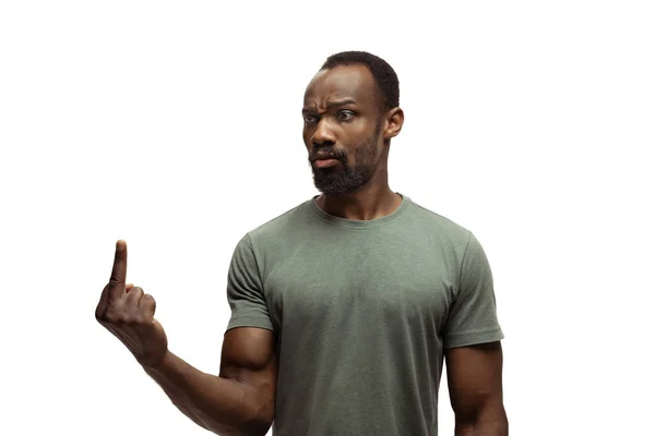 Young african-american man with funny, unusual popular emotions and gestures isolated on white studio background — Stock Photo, Image