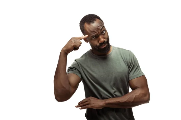 Young african-american man with funny, unusual popular emotions and gestures isolated on white studio background — Stock Photo, Image