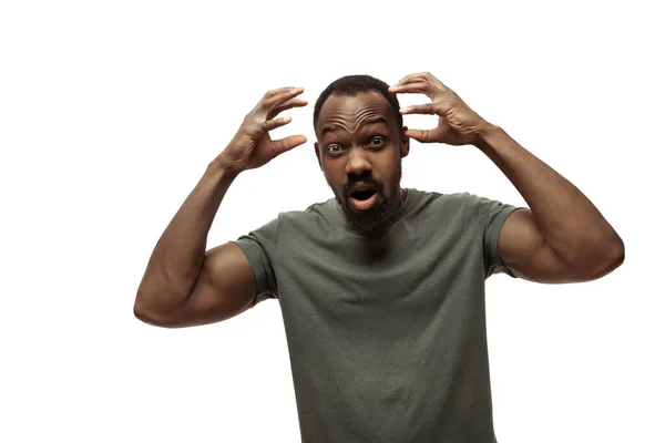 Young african-american man with funny, unusual popular emotions and gestures isolated on white studio background — Stock Photo, Image