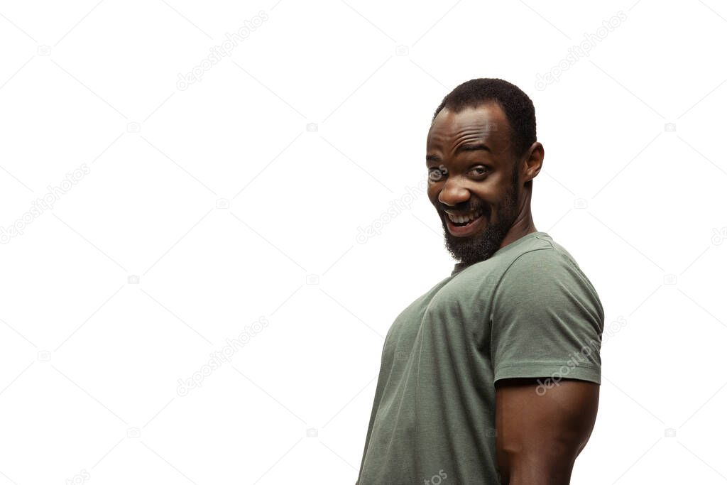 Young african-american man with funny, unusual popular emotions and gestures isolated on white studio background