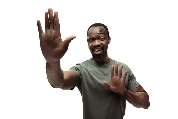 Young african-american man with funny, unusual popular emotions and gestures isolated on white studio background — Stock Photo, Image